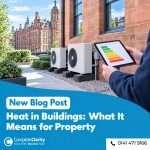Surveyor checking an energy rating beside heat pumps installed at a Glasgow sandstone commercial building