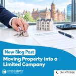 Property owner handing over keys beside a model tenement and a transfer to company document in a Glasgow office