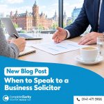 Business owner taking notes while a solicitor explains a contract at a meeting in a Glasgow office